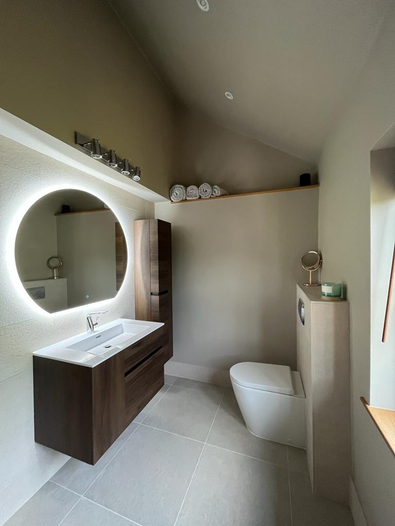 Luxury bathroom installation in Exeter – Modern wet room with high-end tiling, walk-in shower, and stylish fixtures by SBR Property Services Ltd.