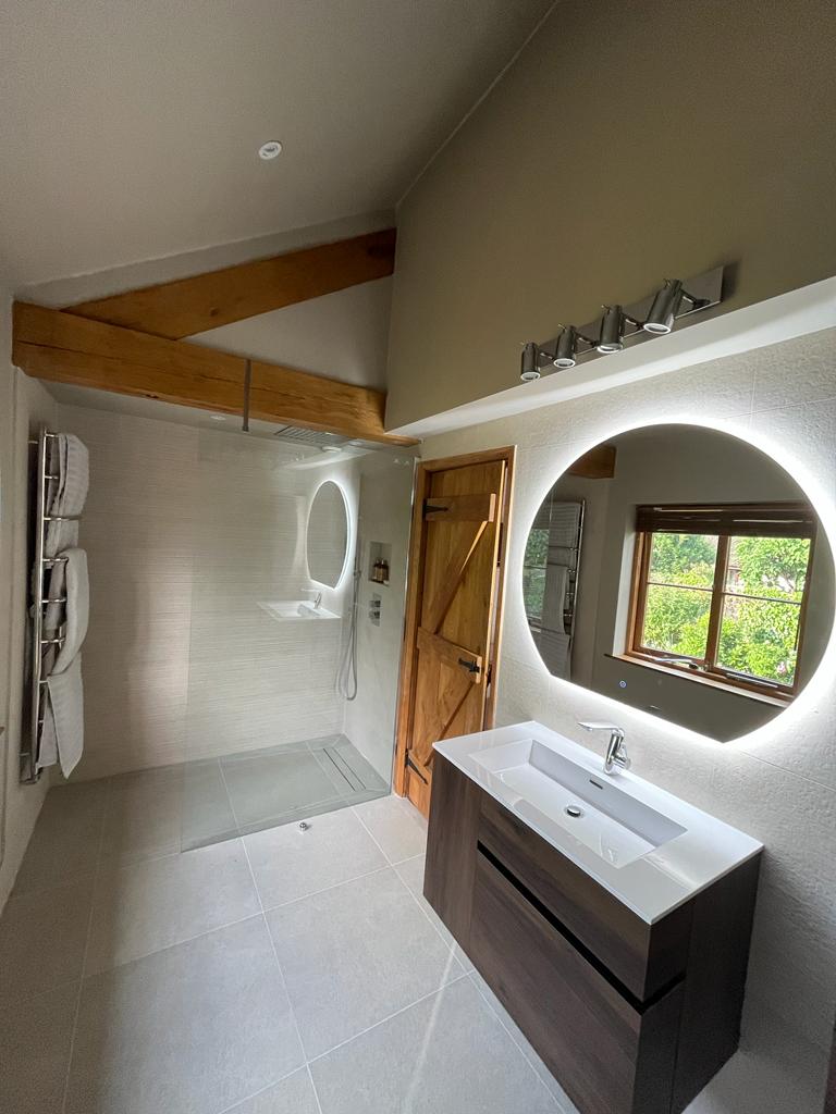 Luxurious shower room with elegant fixtures and contemporary design elements installed by SBR Property Services in Exeter