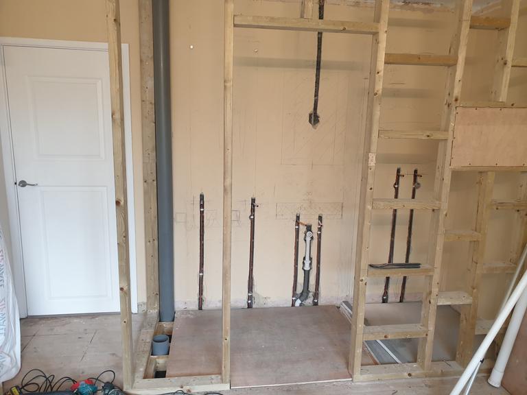 Professionally installed stud wall and reinforced floor for a newly constructed en-suite shower room in a modern Exeter home by SBR Property Services Ltd.